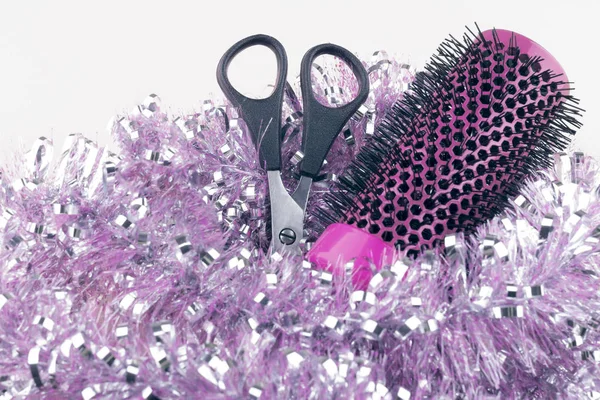 Christmas composition. Hairdressing tools in Christmas tinsel close-up.