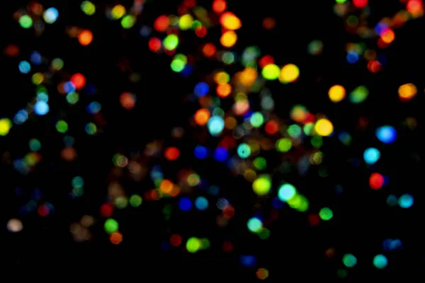 Beautiful and festive blurred lights on black background. — ストック写真