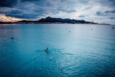 Dişi yüzücü açık denizde yüzer. Denizde antrenman..
