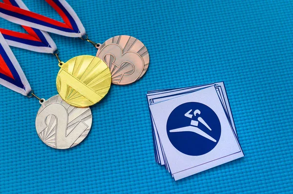 Taekwondo icon and medal set, gold silver and bronze medal, blue background. Original wallpaper for summer olympic game in Tokyo 2020