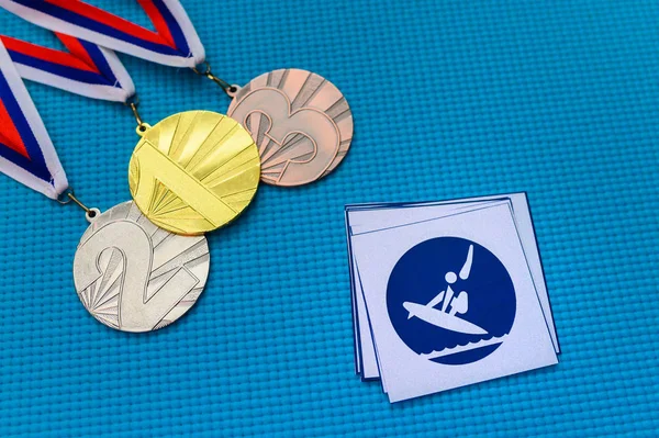 Surfing icon and medal set, gold silver and bronze medal, blue background. Original wallpaper for summer olympic game in Tokyo 2020