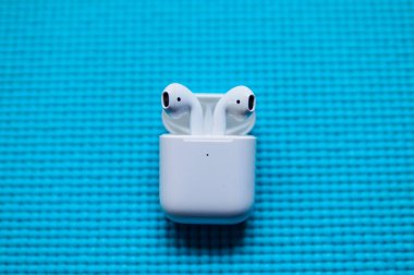 SAN FRANCISCO, USA - FEBRUARY 3, 2020: Apple AirPods Pro, wireless Bluetooth earbuds created by Apple. Blue background. clipart