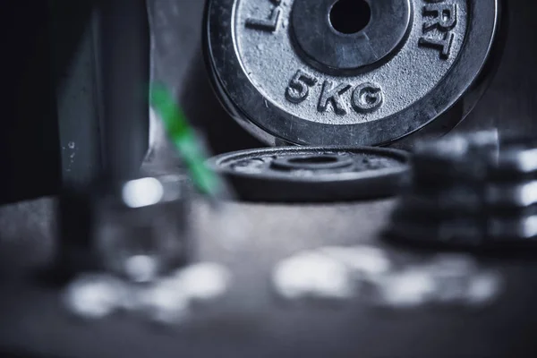 Dope in sports. Dumbbell, syringe drugs on black background