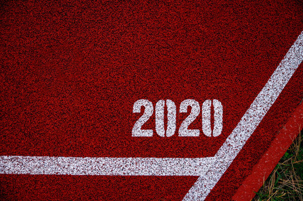 Tittle 2020 at red athletics track, sport background for summer game in Year 2020. Original photo for summer olympic in Tokyo 2020