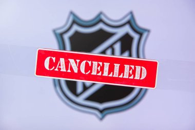 NEW YORK CITY, UNITED STATES OF AMERICA, MARCH. 16. 2020: National Hockey League Cancelled or Postponed due Coronavirus Covid-19. Red tittle CANCELLED and background