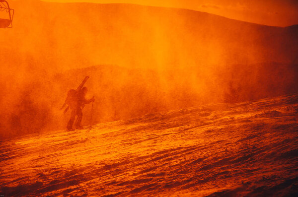 Skier silhouette - orange sunset in winter nature