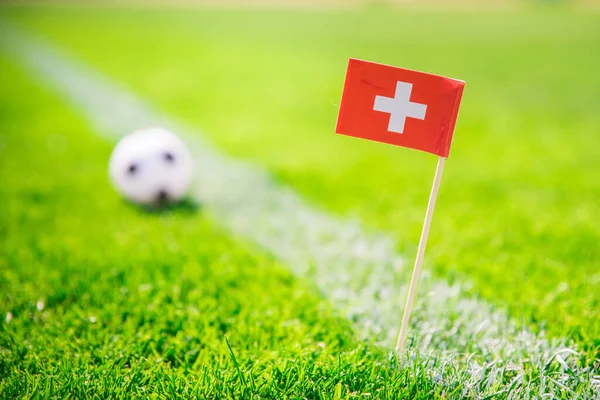 Switzerland national Flag and football ball on green grass. Fans, support photo, edit space