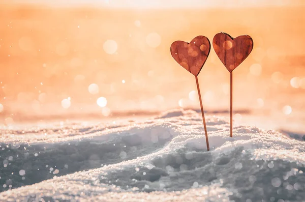 Hearts in warm winter snow - Valentine, romantic date or marriage concept photo with copy space