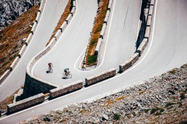 Biker on the road - Cyclist photo. Tour, Italy, Passo dello Stelvio clipart