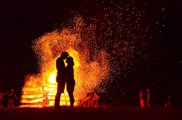 silhouette of loving couple in fire background. Original wallpaper, valentine or wedding theme
