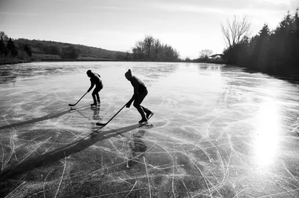 两名冰球选手在自然冰上进行冰球比赛 — 图库照片