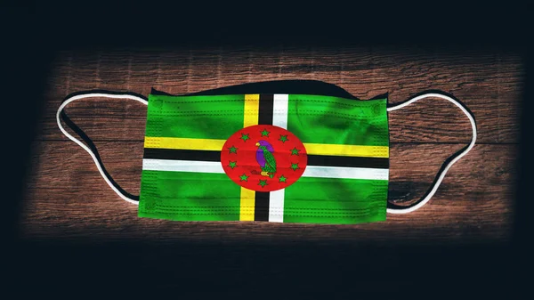 Dominica National Flag Medical Surgical Protection Mask Black Wooden Background — Stock Photo, Image