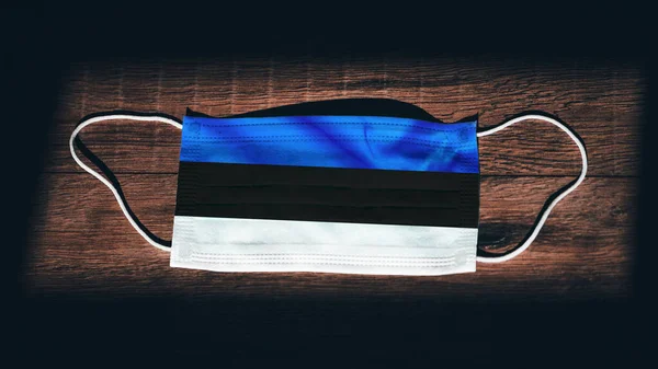 Estonia National Flag Medical Surgical Protection Mask Black Wooden Background — Stock Photo, Image