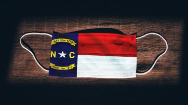 North Carolina Flag. Coronavirus Covid 19 in U.S. State. Medical mask isolate on a black background. Face and mouth masks for protection against airborne infections in USA, America clipart