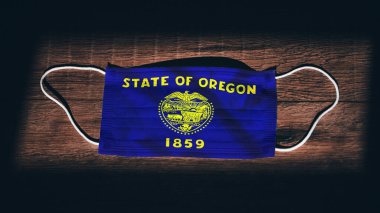 Oregon Flag. Coronavirus Covid 19 in U.S. State. Medical mask isolate on a black background. Face and mouth masks for protection against airborne infections in USA, America clipart