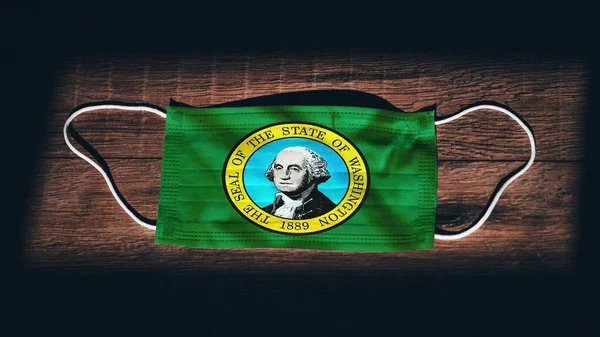 Washington Flag. Coronavirus Covid 19 in U.S. State. Medical mask isolate on a black background. Face and mouth masks for protection against airborne infections in USA, America