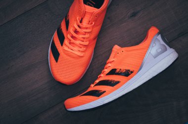 BRATISLAVA, SLOVAKIA - APRIL, 23, 2020: Adidas Adizero Boston 8 Running Shoes, version 2020, range Signal Coral color, Detail photo, Lightstrike foam and Adidas Ultra Boost. Kıtasal taban.