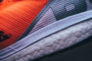 BRATISLAVA, SLOVAKIA - APRIL, 23, 2020: Adidas Adizero Boston 8 Running Shoes, version 2020, range Signal Coral color, Detail photo, Lightstrike foam and Adidas Ultra Boost. Kıtasal taban.