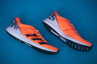 BRATISLAVA, SLOVAKIA - APRIL, 23, 2020: Adidas Adizero Boston 8 Running Shoes, version 2020, range Signal Coral color, Detail photo, Lightstrike foam and Adidas Ultra Boost. Kıtasal taban.
