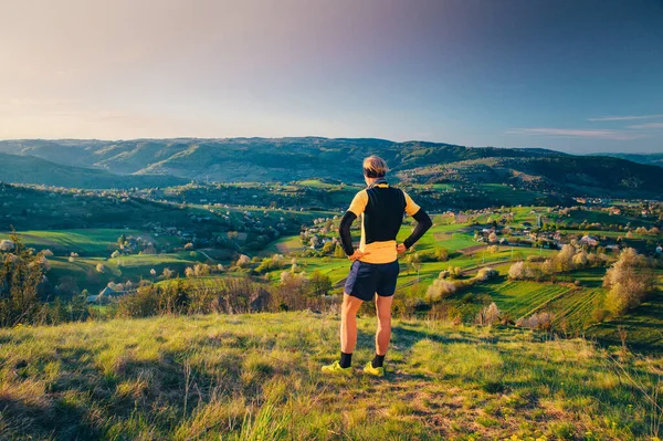 Άνδρας Αθλητής Στέκεται Στην Κορυφή Του Λόφου Και Κοιτάζοντας Όμορφο — Φωτογραφία Αρχείου
