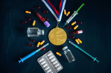 Doping in sport, concept photo. Gold medal, drugs, Medicine bottle for injection medical glass vials. Black edit space for your text clipart