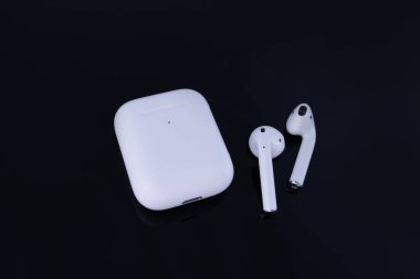 NEW YORK, USA - MAY 19, 2020: Apple AirPods Pro isolated on black background clipart
