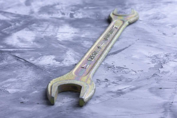 Spanner on a colored background close up background under concrete