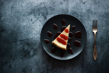 Cheesecake on a plate with strawberry sauce