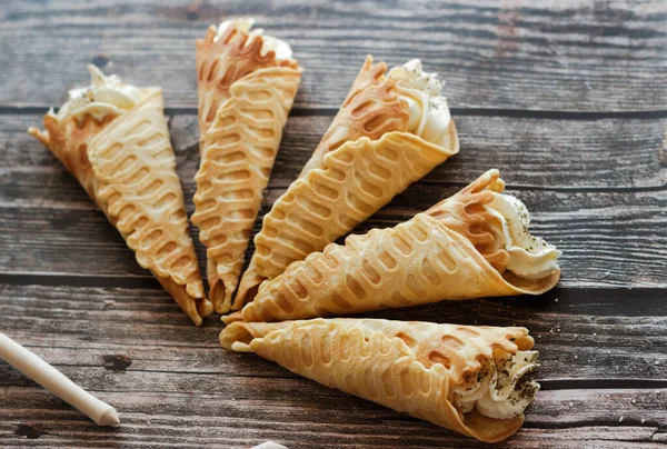 Russian waffles with cream cheese and spices. Wafer rolls on the table. Delicious waffles