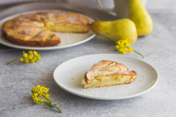 Delicious pear and almond pie. Romantic summer composition with flowers. Pie on a plate