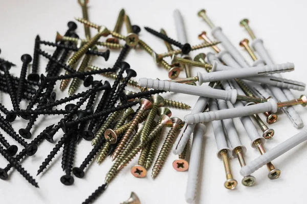 Vida ve dübel-çivi beyaz arka plan üzerinde kendi kendine dokunarak