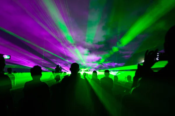 İnsanlar sis, lazer ışığı ve lazer gösterisiyle yıkanıyordu.. 