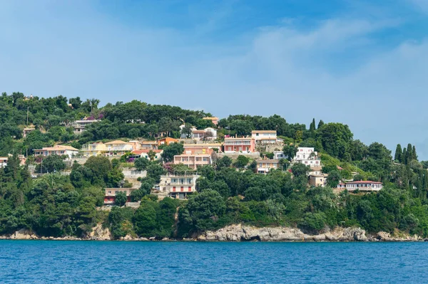 Dağ yamacına evler inşa edildi. Sahildeki ağaçların arasına..