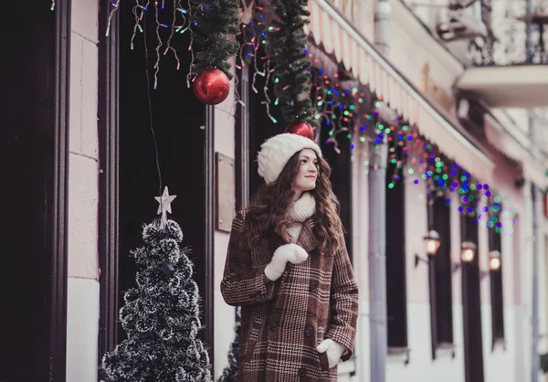 happy woman in mittens and knitted hat