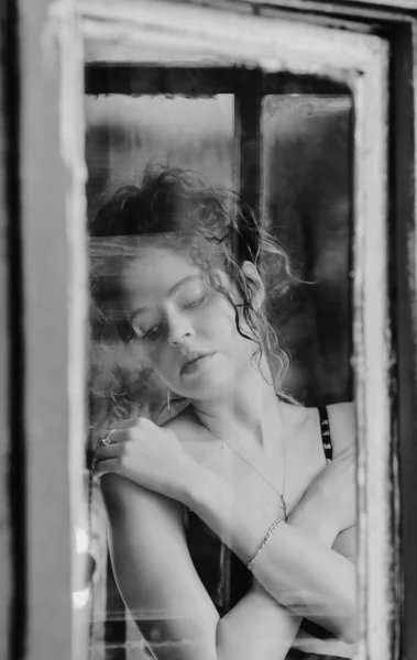 beautiful woman in the window