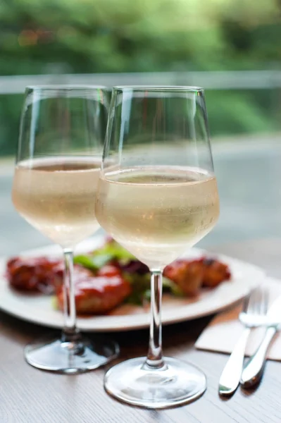 Dos copas de delicioso vino blanco refrigerado con merienda en restaur — Foto de Stock