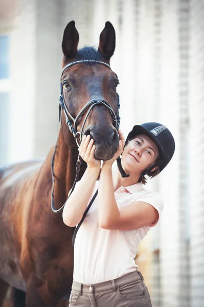 Alegre sonriente adolescente ecuestre sosteniendo divertido caballo sno — Foto de Stock