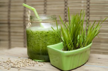 yeşil smoothie cam kavanozda taze salatalıkla ahşap masada