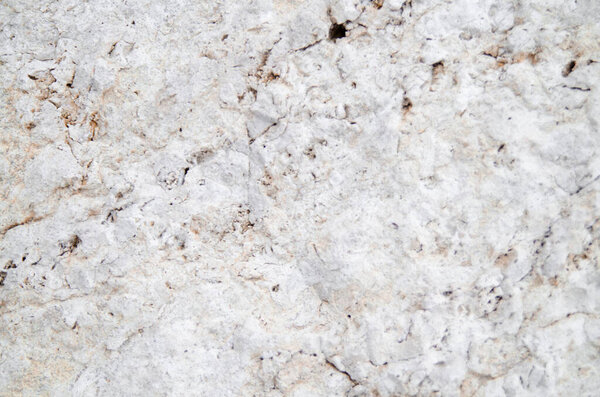 Gray white stone of natural rock background texture.Weathered rough texture surface detail close up