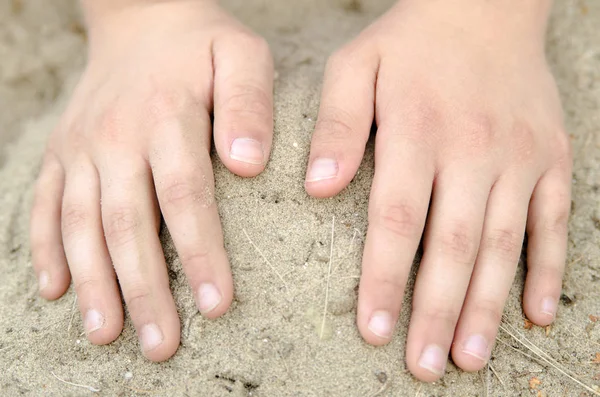 Child hands holding sand. Symbol for passing time or dry land. Enjoying Time in nature.
