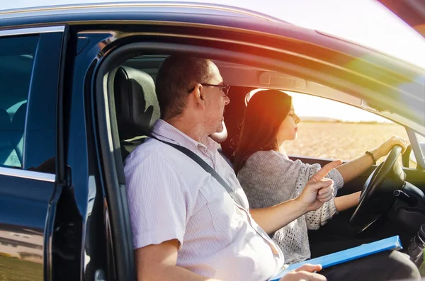 Teen girl driving father by car for the first time. Teenage Woman and man Going on small trip together