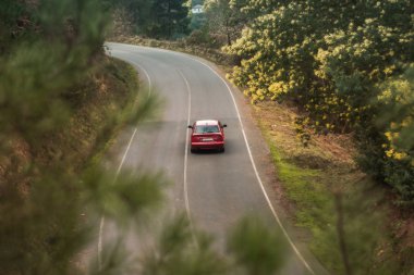 mountain road with a red car