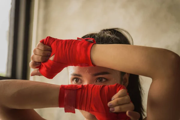 Genç kadınlar spor salonunda kickboks yapıyor..