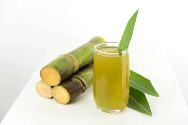Fresh sugar cane juice in glass on table white background — Stock Photo, Image