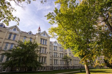 Traverse City, Michigan, USA - October 1, 2017: Exterior of the former Northern Michigan Asylum, now known as the Grand Traverse Commons. The campus offers tours, upscale condos and boutique shops. clipart