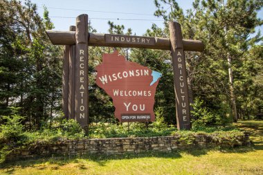 Florence, Wisconsin, USA - July 6, 2019: State of Wisconsin welcome sign at the border of Wisconsin and Michigan. clipart