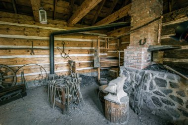 Historic Blacksmith Shop. Interior of blacksmith shop at Fort Wilkins State Park in Copper Harbor, This is a public building formerly owned by the US Government and now owned by the state of Michigan. clipart