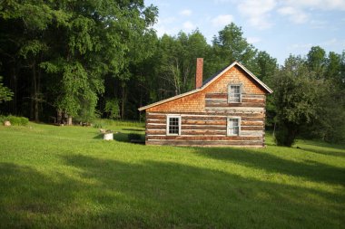 Log Cabin Homestead. Rustic log cabin in the woods of northern Michigan. This is a historical structure in a national park and not a privately owned property or residence.  clipart