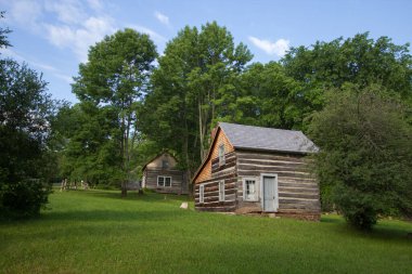 Log Cabin Homestead. Rustic log cabin in the woods of northern Michigan. This is a historical structure in a national park and not a privately owned property or residence.  clipart