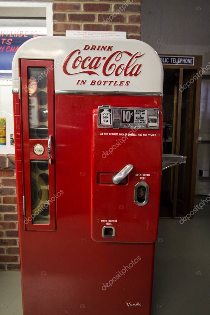 Amarillo, Texas, USA - February 24, 2020: Close up of antique Coca Cola brand vending machine from the 1950s era in vertical orientation.